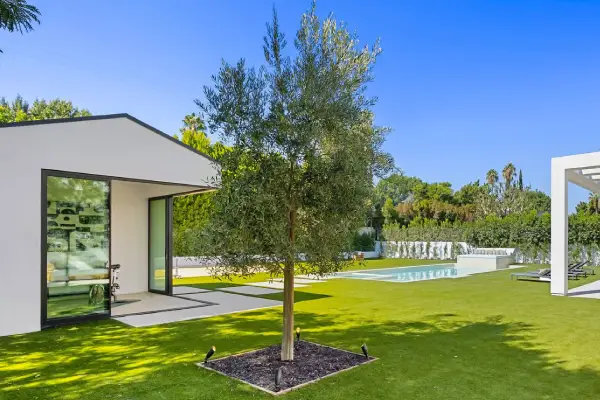 Modern luxury home with pool and patio.