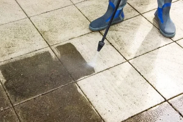 Patio tiles being power washed